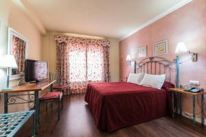 Säng eller sängar i ett rum på Hotel Guadalquivir