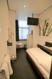 Postel nebo postele na pokoji v ubytování Hotel Bienvenue