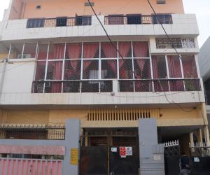 a building with a lot of windows at RK appartment 3 bedroom with kitchen and balcony in Varanasi