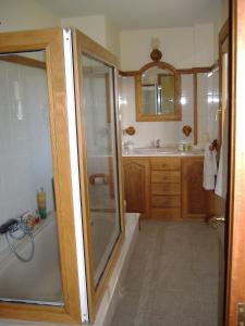 a bathroom with a shower and a tub and a sink at CHALT EN MIÑO CON VISTAS AL MAR in A Coruña