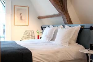 Postel nebo postele na pokoji v ubytování Hotel Julien