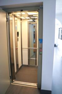 an elevatorexit in a building with a glass door at Hostal Castillo in San José de la Rinconada