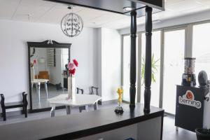 a living room with a table and a mirror at Hostal Castillo in San José de la Rinconada