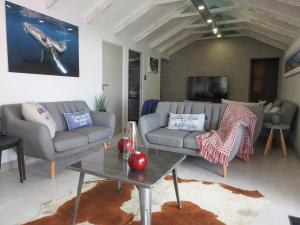 a living room with a couch and a table at Kango 10 in Hartenbos