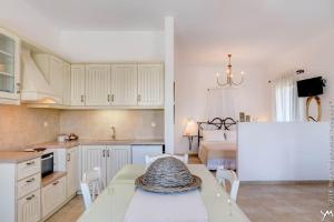 a kitchen and living room with a table and a bed at Opalio Apartments in Kimolos