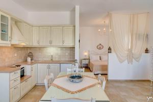 a kitchen and living room with a table and a couch at Opalio Apartments,Kimolos in Kimolos