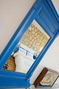 a blue frame of a bed with pillows at Kesre Hotel in Alacati
