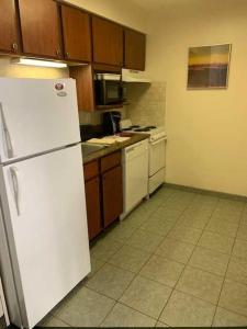 
a kitchen with a refrigerator, stove, sink and dishwasher at Host Inn an All Suites Hotel in Wilkes-Barre
