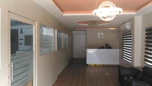 a lobby with a reception counter and a chandelier at The Orchid Suites in Kollam