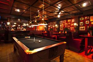 a bar with a pool table in a room at Hotel de Markt in Valkenswaard