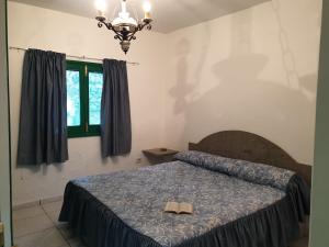 Кровать или кровати в номере Villa de Cactualdea