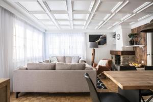 a living room with a couch and a table at Chalet Josianne in Saas-Fee