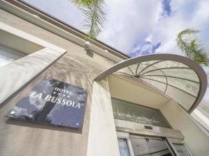 a sign on the side of a building at Hotel La Bussola in Milazzo