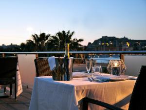 a table with a bottle of wine on a balcony at Hotel La Bussola in Milazzo