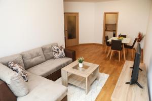 a living room with a couch and a table at Apartman Aurora in Solde