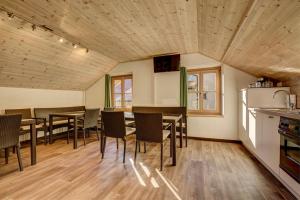 a kitchen and dining room with tables and chairs at Unterdornerhof in Lagundo