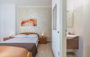 Postel nebo postele na pokoji v ubytování Apartment Complex Orzan Lovrecica