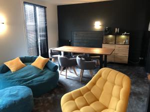 a living room with a table and a couch at Logis Chez Camillou in Aumont-Aubrac