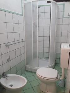 a bathroom with a toilet and a shower and a sink at Casa Maria in Lampedusa