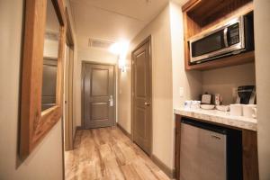 a small kitchen with a sink and a microwave at Driftwood Lodge in Springdale