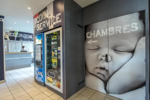 a store with a display of advertisements for a baby at ibis budget Vienne Sud in Vienne