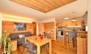 uma sala de estar e cozinha com uma mesa e um sofá em Appartements Mayrhof em Bressanone