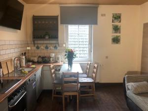 a kitchen with a table and chairs in a kitchen at Westfalische Apartments in Lennestadt