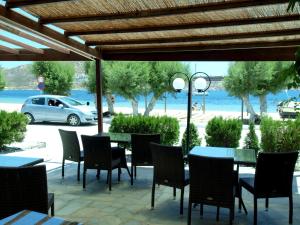 a patio with a table and chairs and a car at Asteri Hotel in Livadi