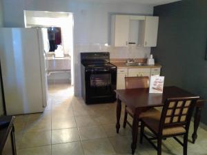 a kitchen with a table and a stove and a refrigerator at Express Inn & Suites - 5 Miles from St Petersburg Clearwater Airport in Clearwater