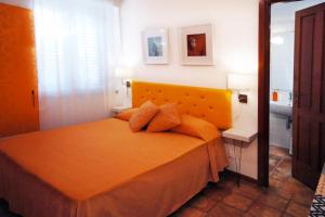a bedroom with a bed with an orange bedspread at Villa Di Papa' in Gaeta +42 photos