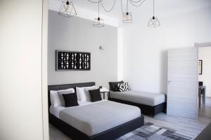 Krevet ili kreveti u jedinici u objektu Palazzo Mormando - Modern Apartment
