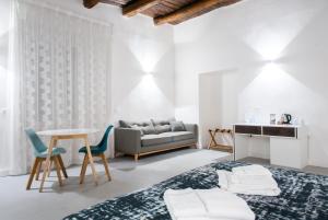 a bedroom with a bed and a table and a couch at Dada Suite in Naples