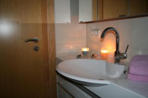 a bathroom with a sink with two candles on it at Ferienwohnung Dieter Popp in Münchberg