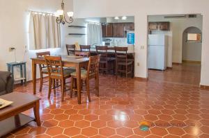 a kitchen and dining room with a table and chairs at Casita Blanca by FMI Rentals in Puerto Peñasco