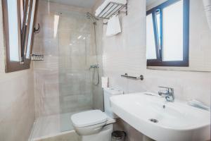 a bathroom with a toilet and a sink and a shower at Solesperit in Lloret de Mar