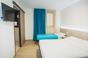 a hotel room with two beds and a flat screen tv at Solesperit in Lloret de Mar +24 photos