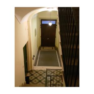 a view of a hallway with a black door at B&B Domvs tva in Chieti