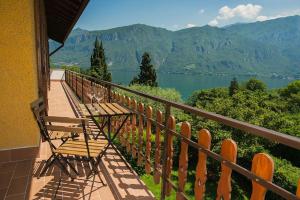 a balcony with a bench and a view of a lake at Casa Sissi in Bellagio