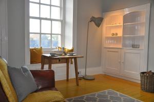 a living room with a table and a window at Emahroo Cullen in Cullen