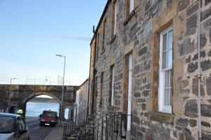 a brick building on a street with a bridge at Emahroo Cullen in Cullen