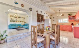 a kitchen and living room with a table and chairs at Ina Apartment in Kalamaki