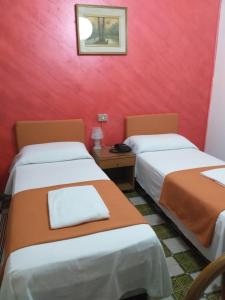Postel nebo postele na pokoji v ubytování Hotel Arcella