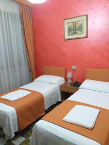 Postel nebo postele na pokoji v ubytování Hotel Arcella