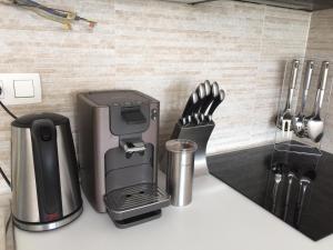 a kitchen counter with a coffeemaker and a coffee maker at Les terrasses de Malmédy in Malmedy
