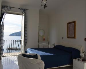 a bedroom with a bed and a view of the ocean at Casa della Luna in Amalfi