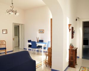 a living room with a table and blue chairs at Casa della Luna in Amalfi