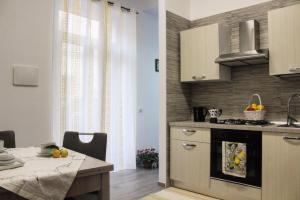 a kitchen with a sink and a stove top oven at Case Vacanze Mare Blu in Castellammare del Golfo
