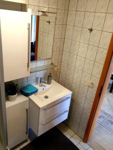 a bathroom with a sink and a mirror at Wohlfühl-Apartment Bad Kissingen I in Bad Kissingen