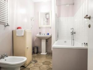 a bathroom with a sink and a toilet and a bath tub at Mecenate Rooms in Rome