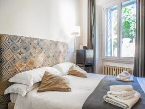 a bedroom with a bed with towels on it at Mecenate Rooms in Rome